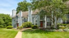entrances to townhomes with lush green landscaping