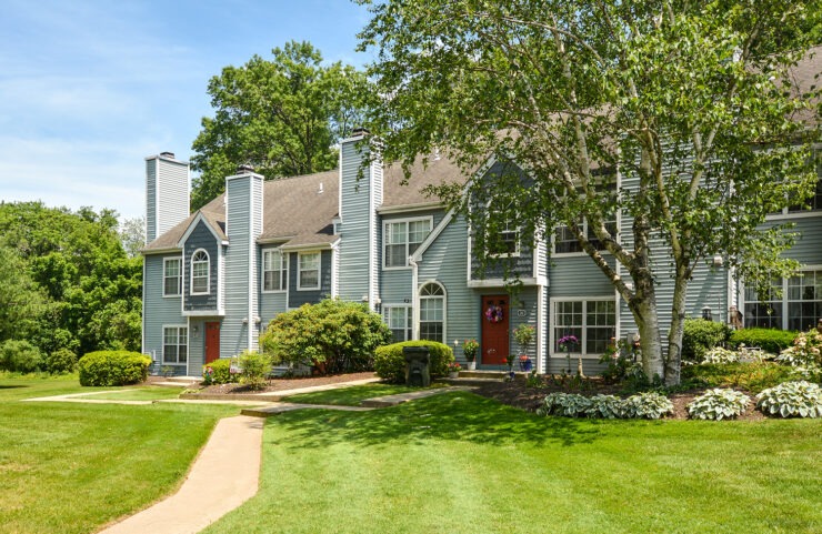 entrances to townhomes with lush green landscaping
