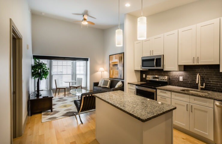 Modern Kitchen With Stainless Steel Appliances, Granite Countertops and Designer Lighting
