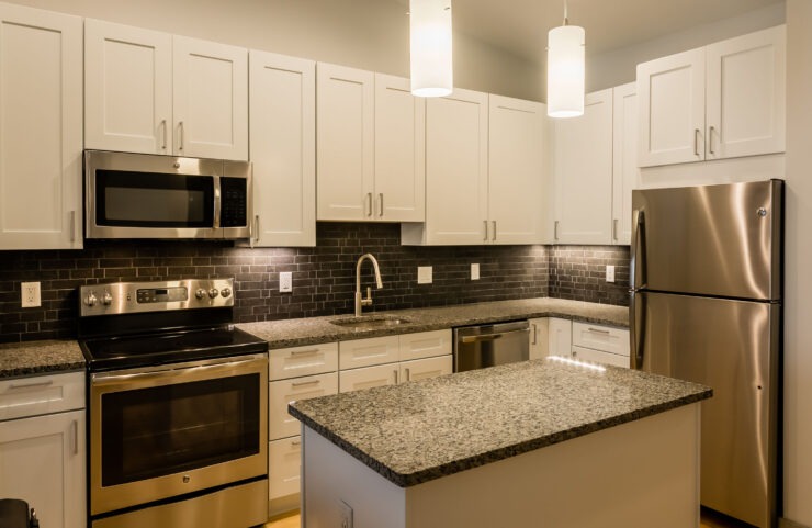 Modern Kitchen With Stainless Steel Appliances, Granite Countertops and Designer Lighting