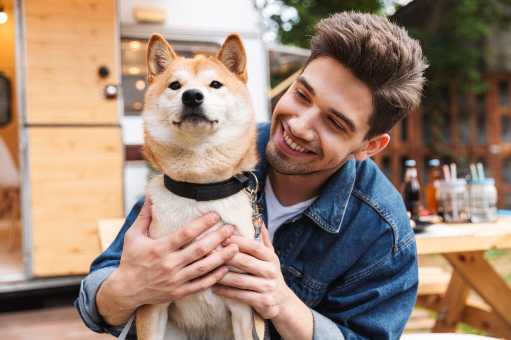Man smiling and wearing denim clothes hugging
