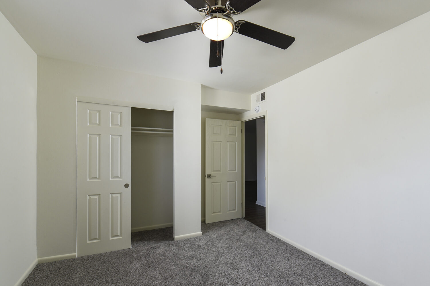 Bedroom with large closet and ceiling fan