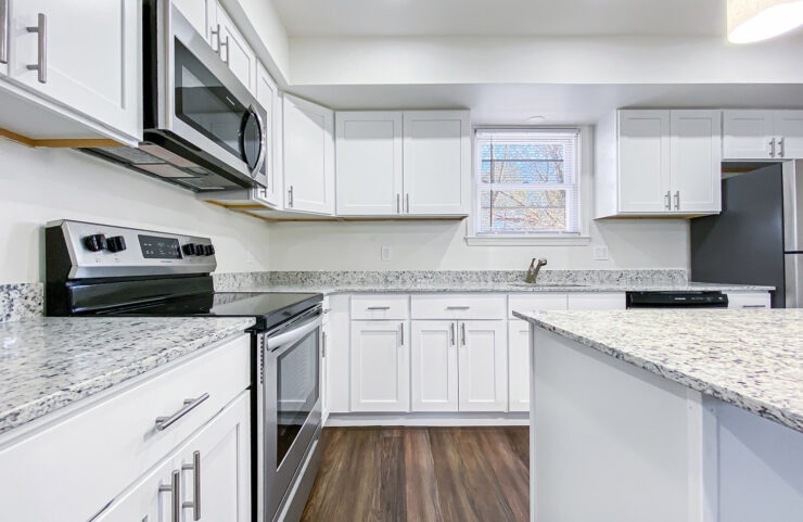 upgraded kitchen with white and gray granite countertops