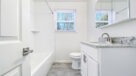 upgraded bathroom with white vanity 