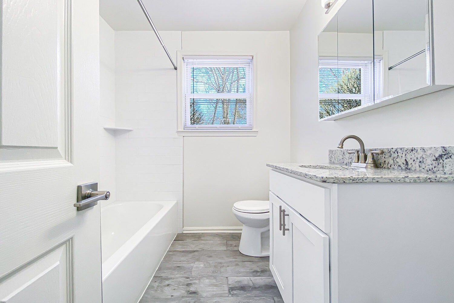 upgraded bathroom with white vanity 