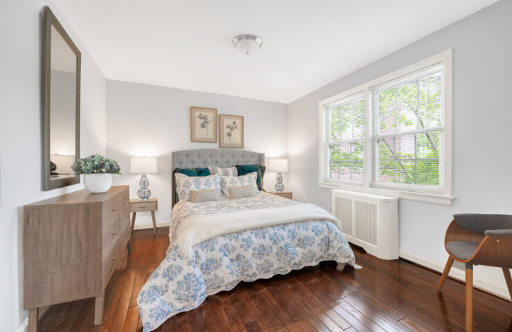 bedroom with large window and plank flooring