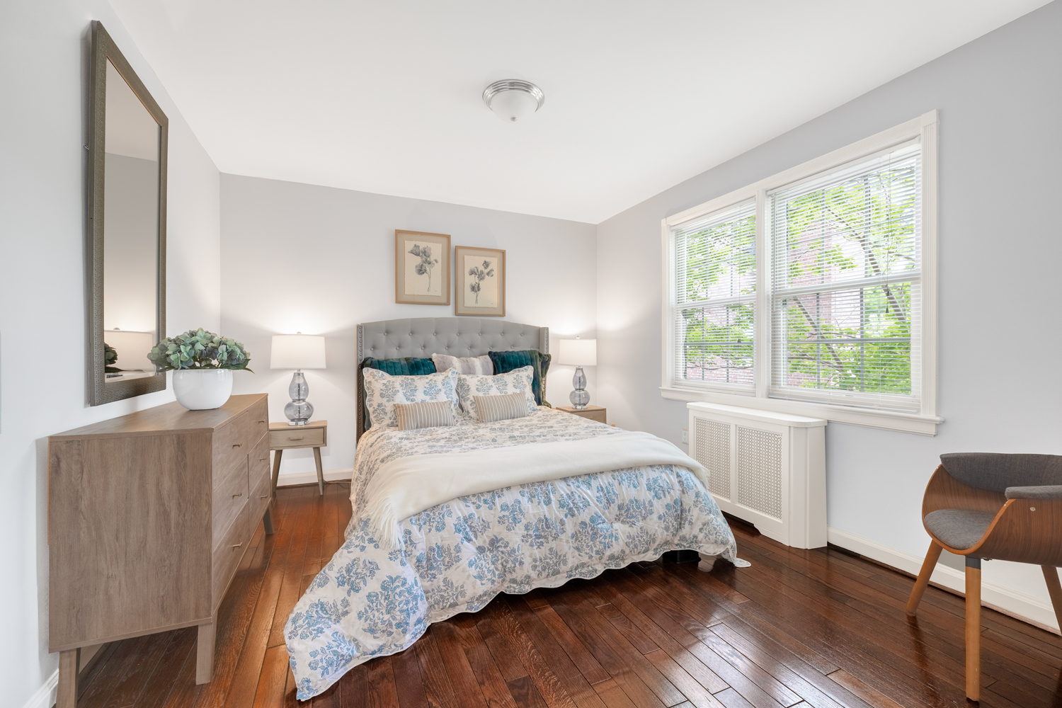bedroom with large window and plank flooring