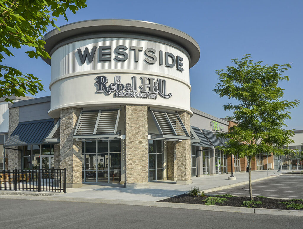 Large, round building that reads "Westside" on top and "Rebel Hill Brewing Company" below,