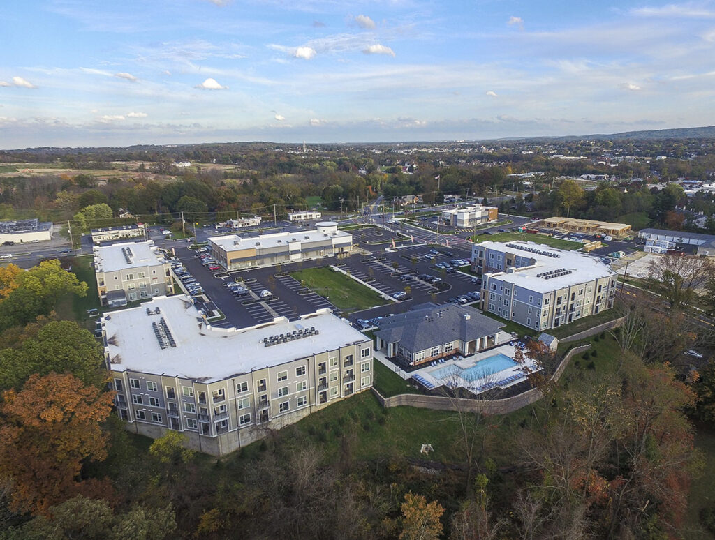 Aerial view of the Westside Apartment community with a lot of trees and greenery in the background