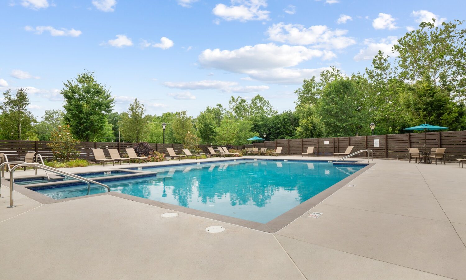 Resort style swimming pool with sun shelf and hot tub