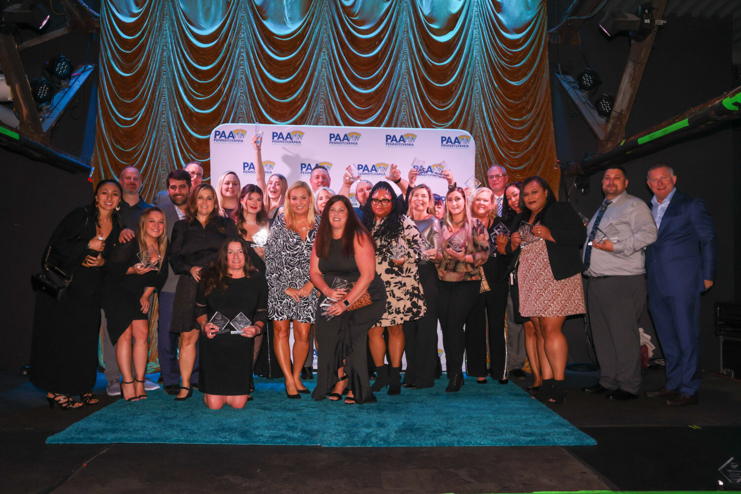 Group photo of Scully Company employees smiling and showing off their awards.