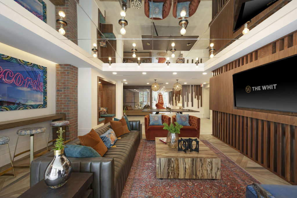 TV lounge at The Whit apartments with couches and a large television