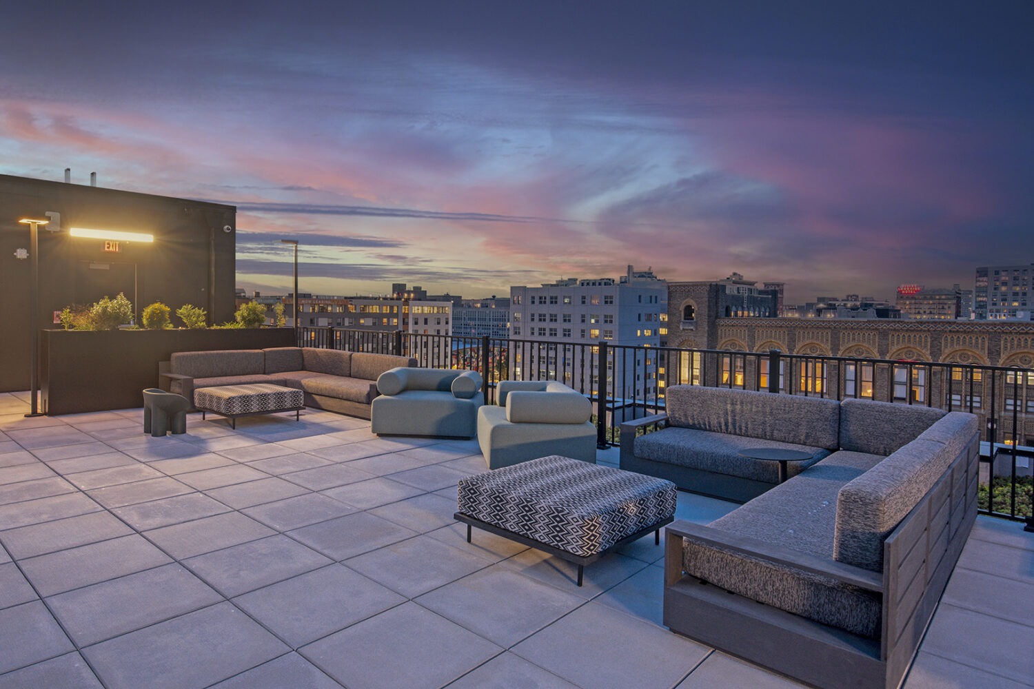 Rooftop lounge with plentiful seating at dusk