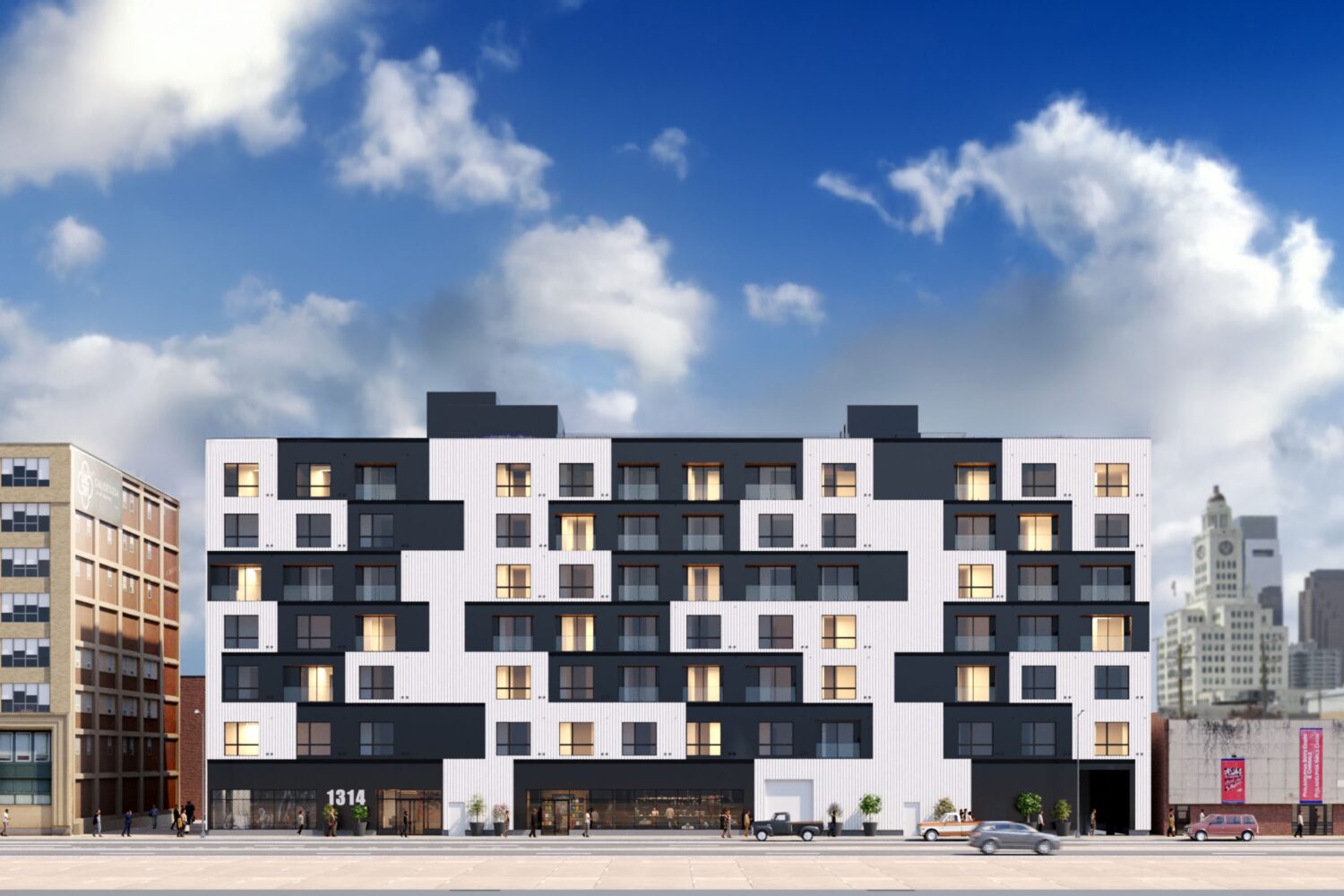 Black and white building in front of blue sky with clouds