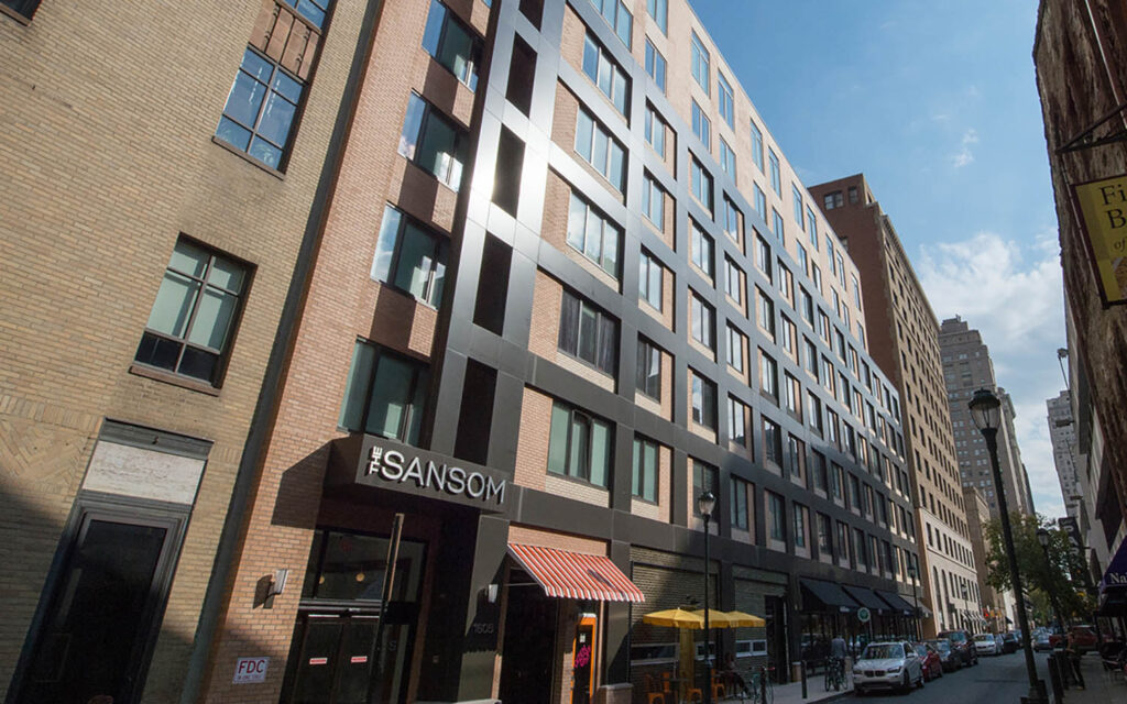 The Sansom Apartments building from the side with blue sky in the back