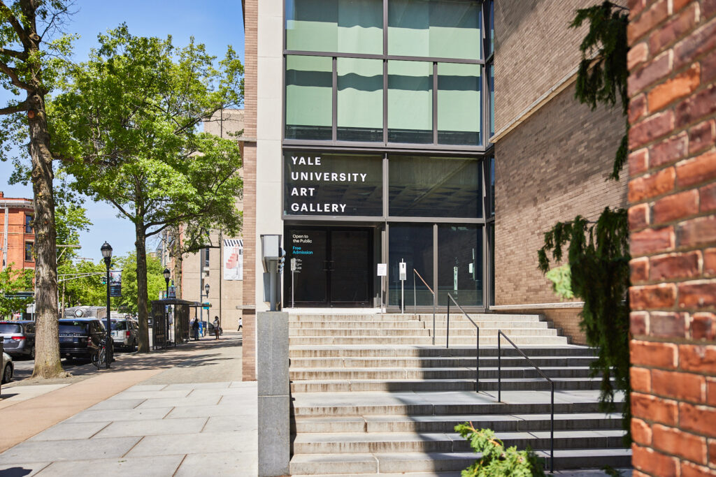 Steps up to a brick building with glass that reads "Yale University Art Gallery"