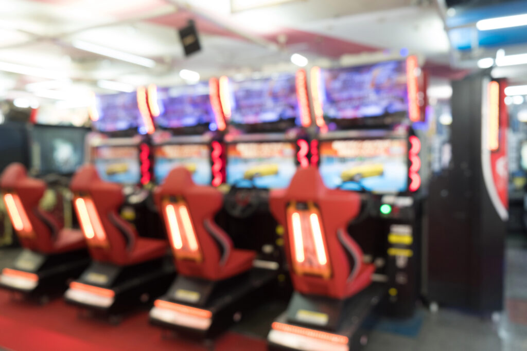 Arcade games with red seats and steering wheels