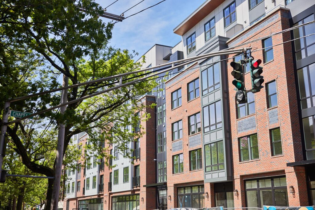 Front view of The Whit apartments surrounded by trees