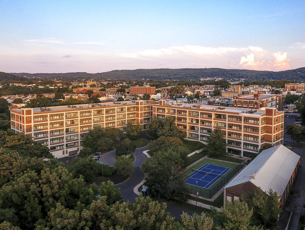 Aerial view of Bridgeview Apartments in Allentown with hills and clouds in the background