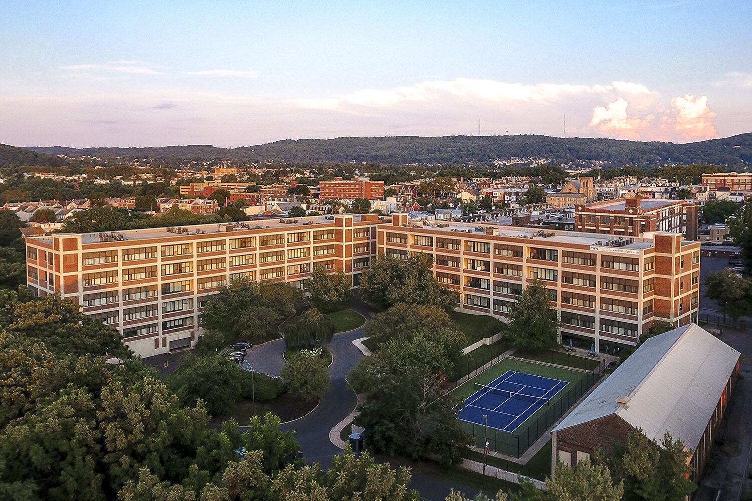 Aerial view of Bridgeview Apartments in Allentown with hills and clouds in the background