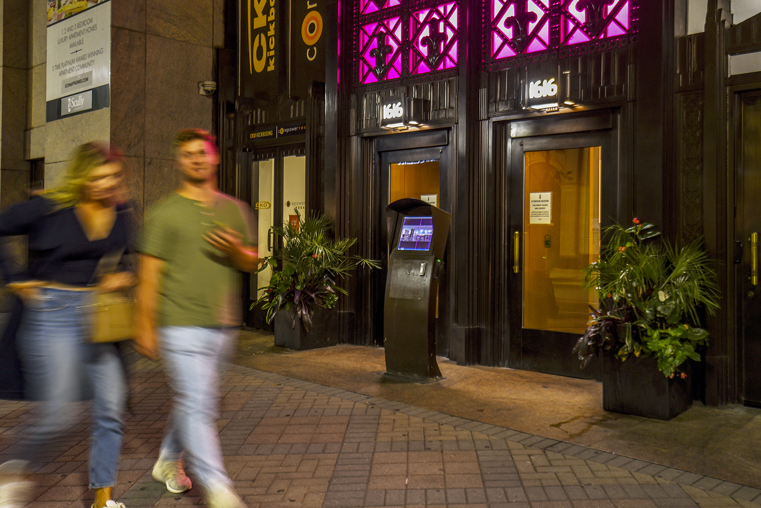 Couple walking past ICON Apartments on Walnut Street