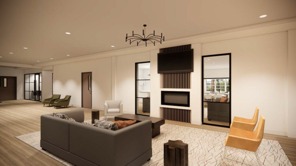 Resident lounge with a television, couches, and warm lights