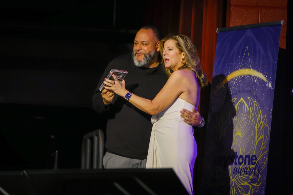 PAA Keystone award winner on stage with award