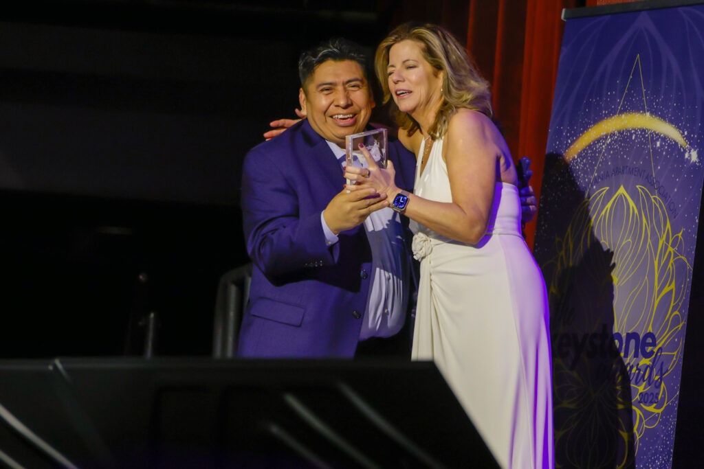 PAA Keystone award winner on stage with award