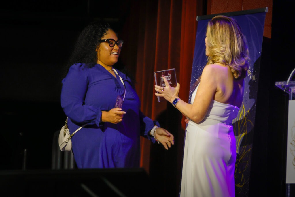 PAA Keystone award winner on stage with award