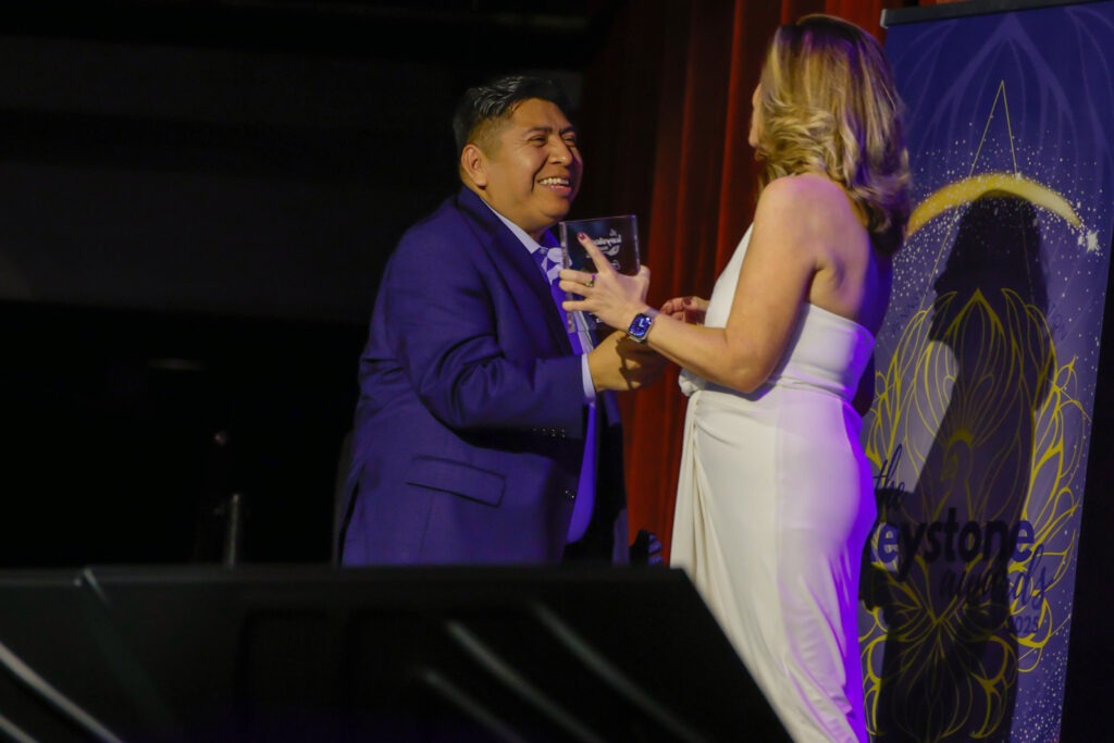 PAA Keystone award winner on stage with award