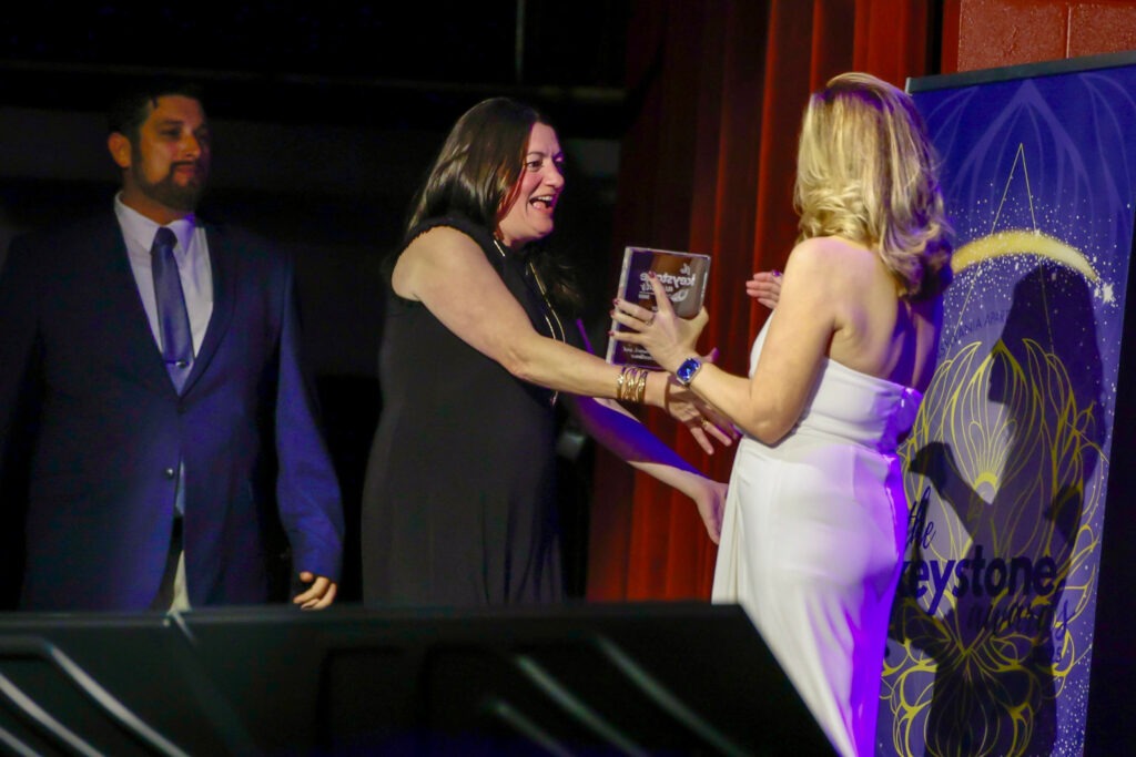 PAA Keystone award winner on stage with award