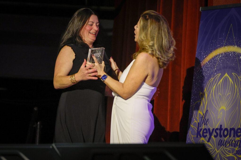 PAA Keystone award winner on stage with award