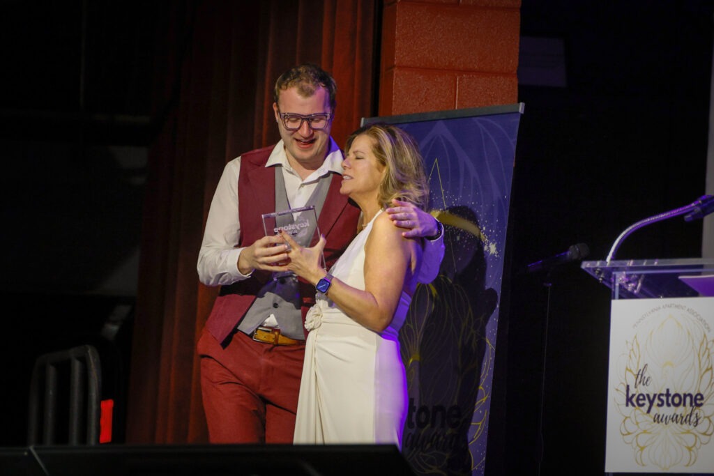 PAA Keystone award winner on stage with award