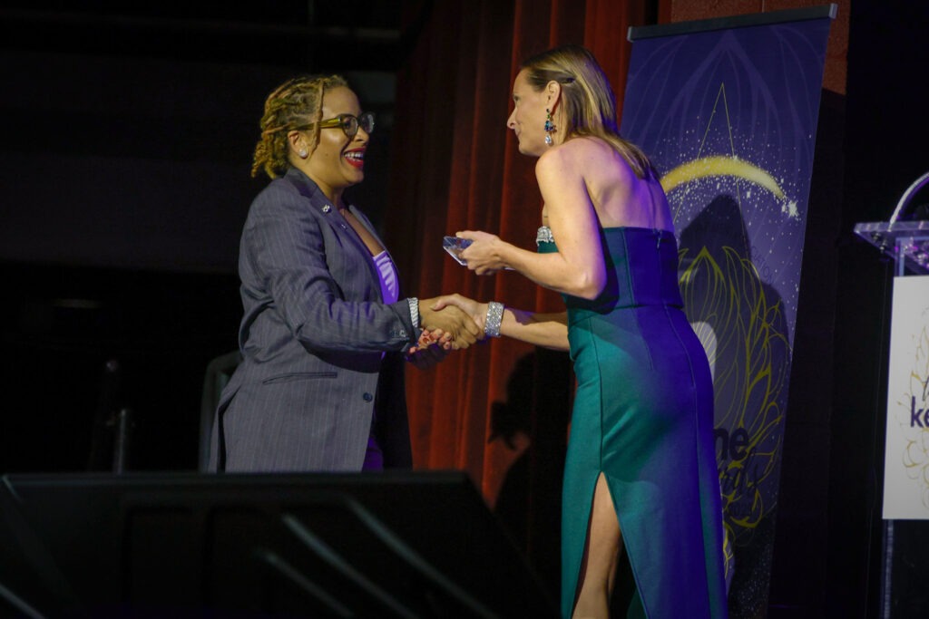 PAA Keystone award winner on stage with award