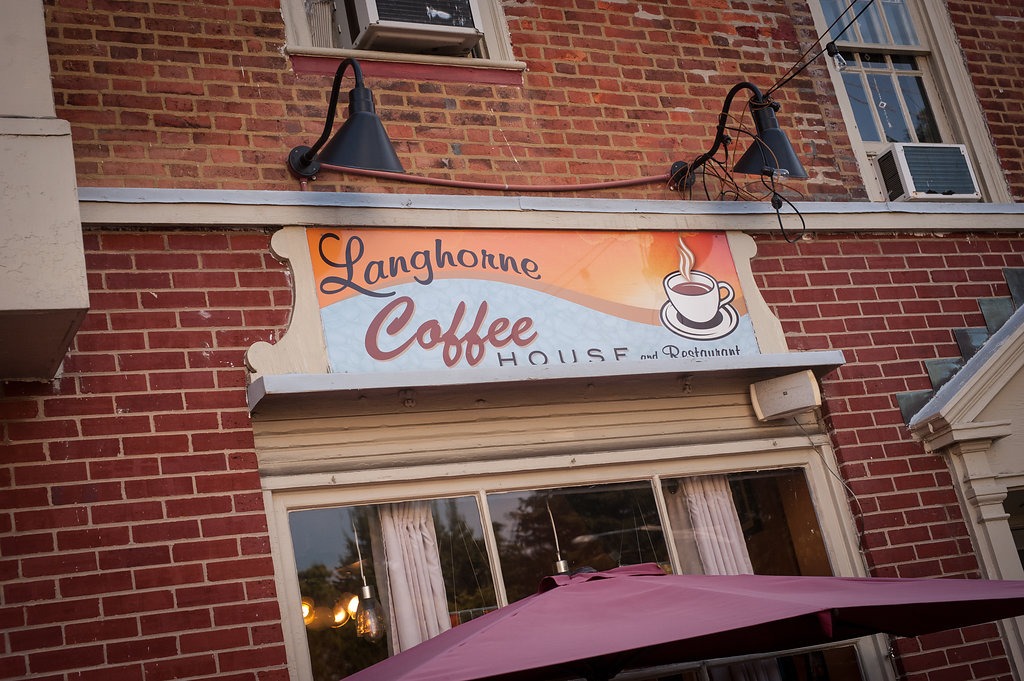 Coffee shop inside a brick building with a sign reading "Langhorne Coffee House"