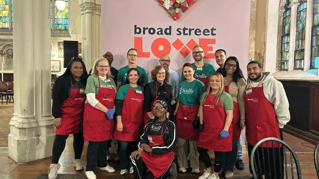 Group of Scully Company employees volunteering at Broad Street Love in red aprons