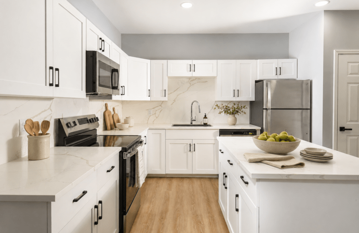 Kitchen With Efficient, Modern Stainless Steel Appliances and Quartz Countertops and Pendant Lighting