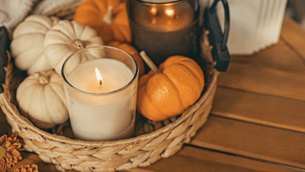 mini pumpkins and a candle in a basket for apartment decorations