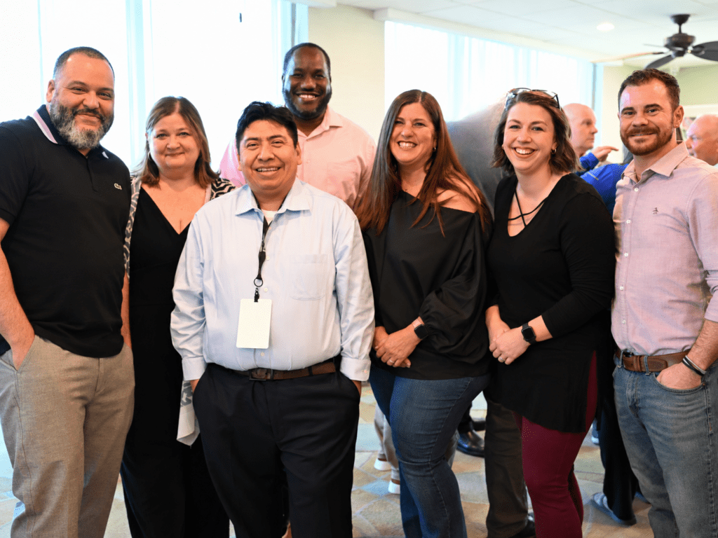 Seven Scully Company employees smiling for the camera